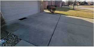 Concrete driveway after pressure washing — restored and clean